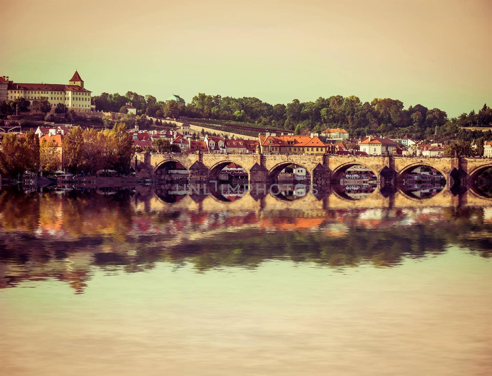 beautiful view of the Charles Bridge and other sights with reflection in Prague, Czech Republic
