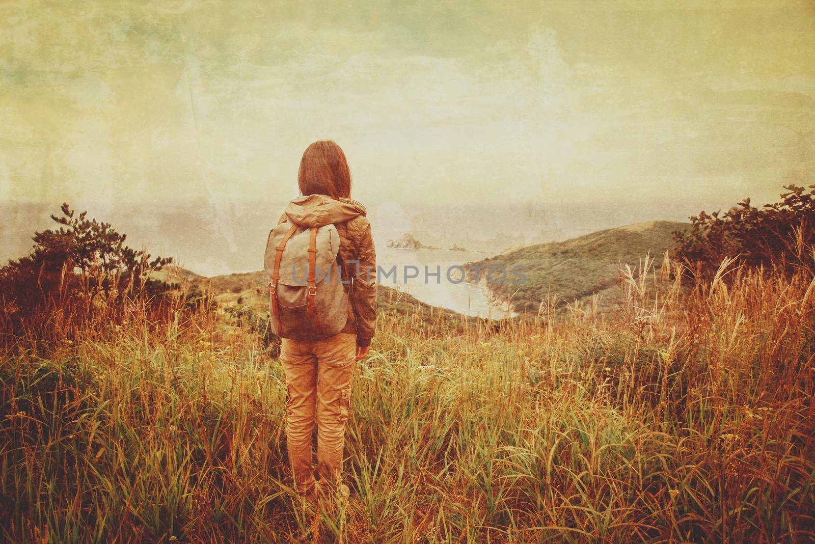 Hiker young woman with backpack walking in the mountains in summer. Vintage image