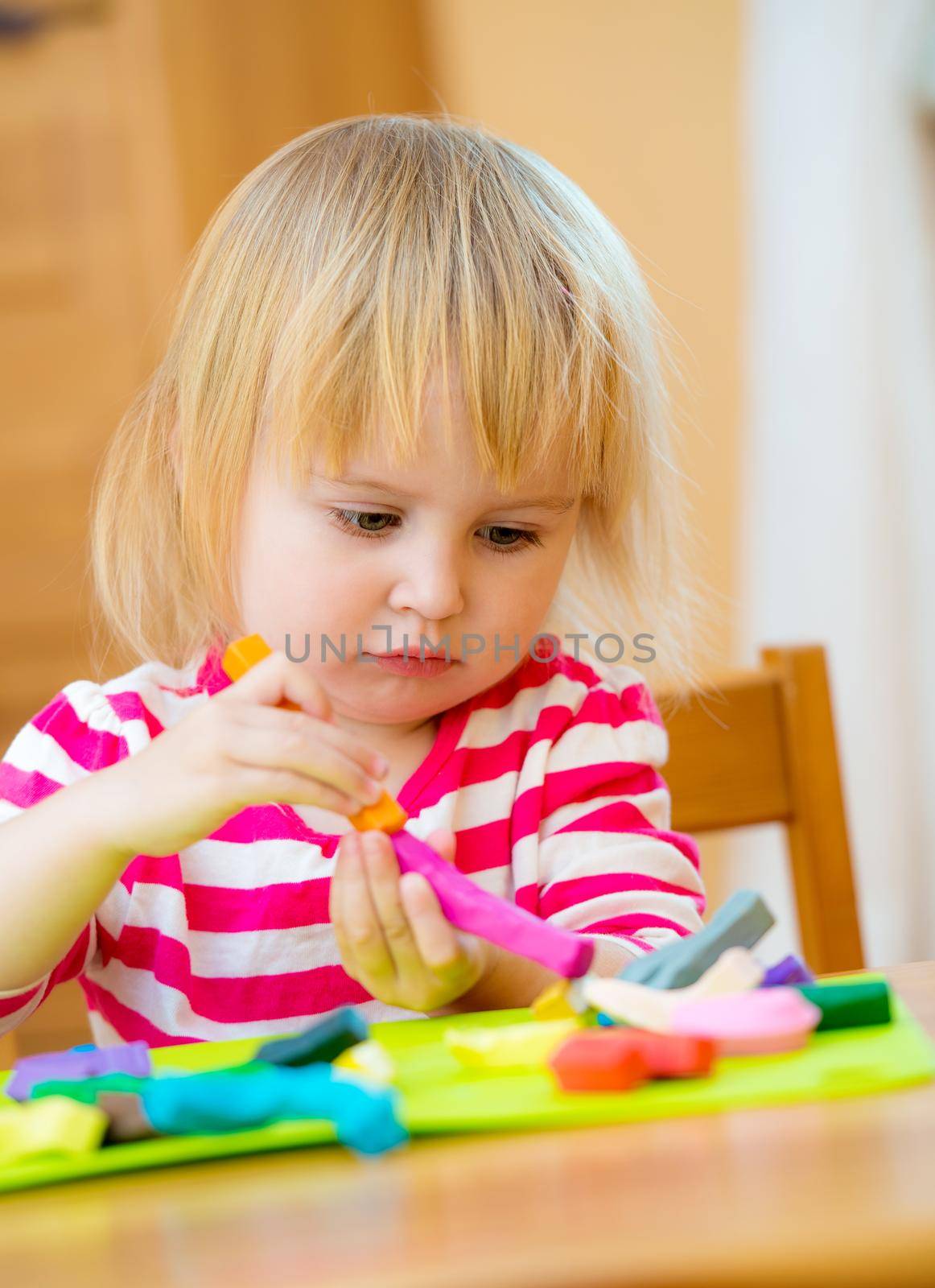 lovely little girl engaged in modeling plasticine by GekaSkr