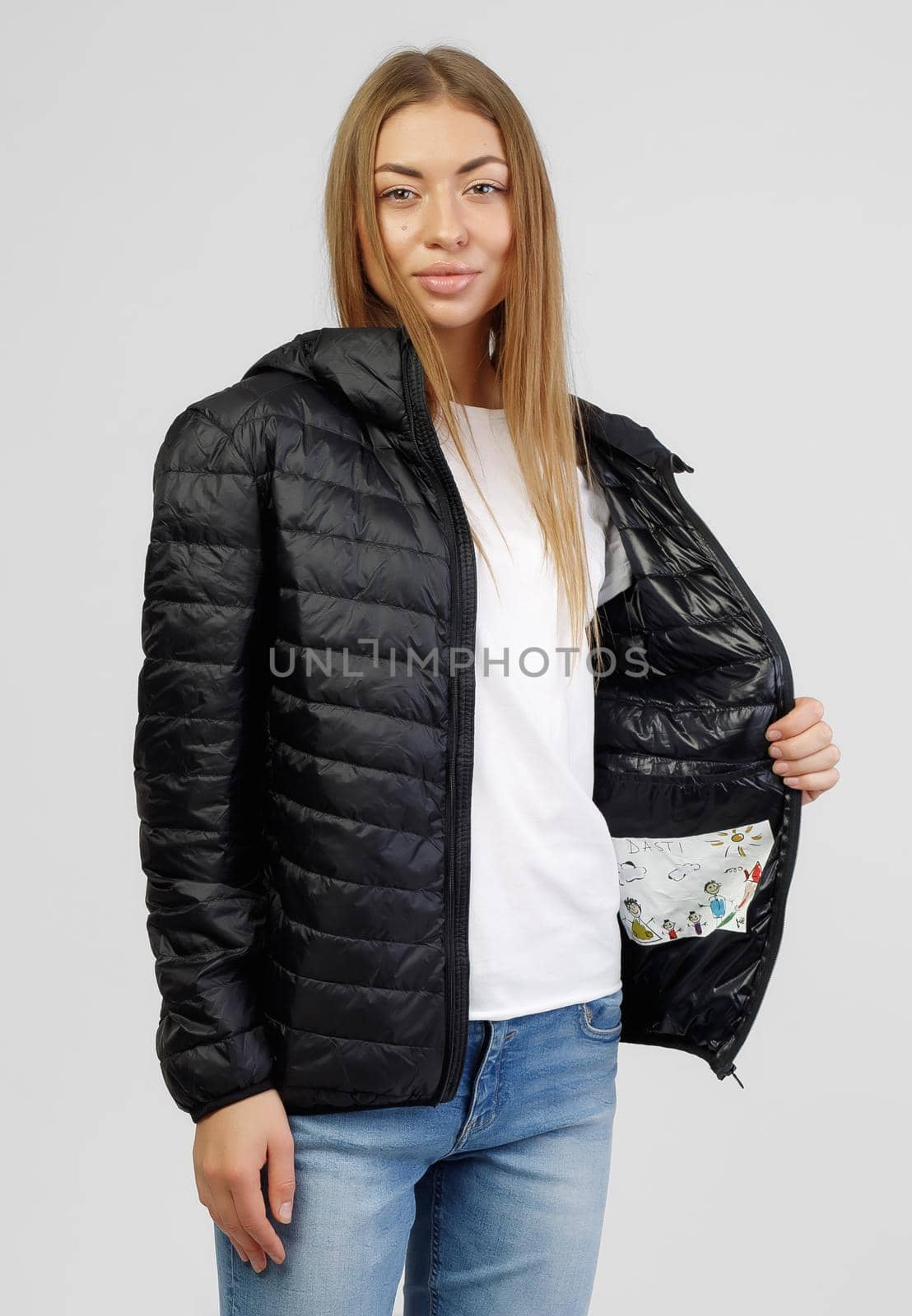 Young female model posing in black down jacket isolated on white background. Winter and autumn women down jacket mockup by UcheaD