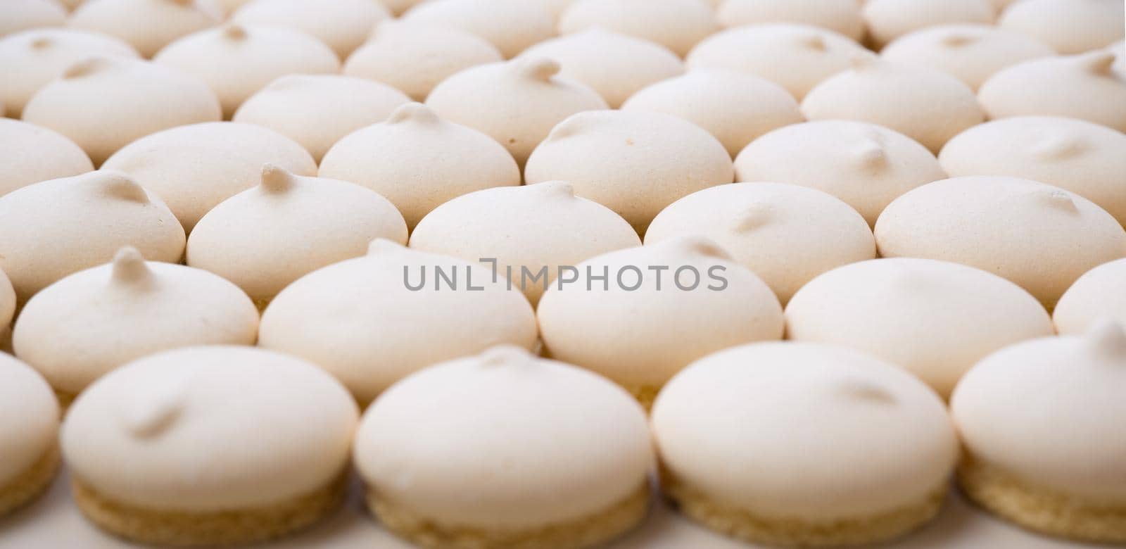 Background of sugar cookies in white glaze, close-up view, shot from above.