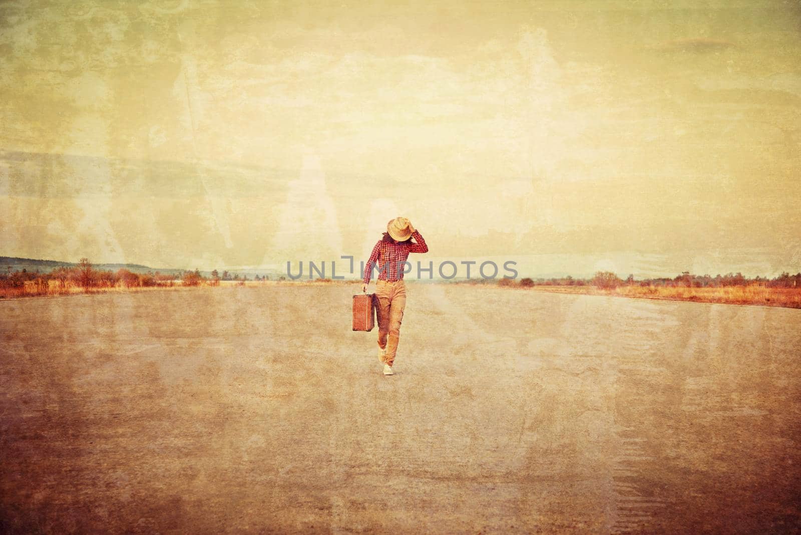 Traveler woman is running with suitcase on road. Vintage image