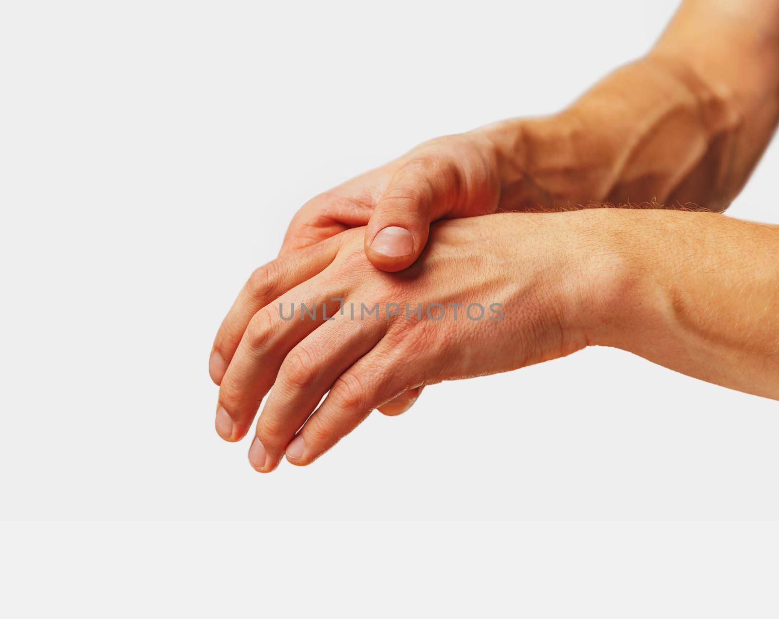 Pain in a male hand. Man holds his hand.