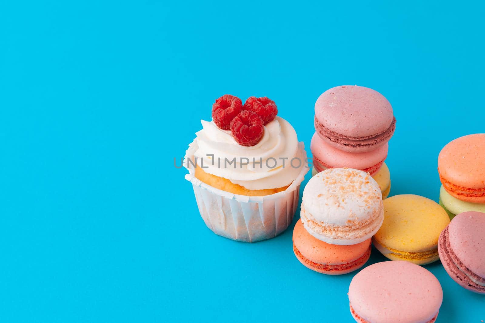 Set of various fondant cupcakes ready to be eaten - bright and colorful set
