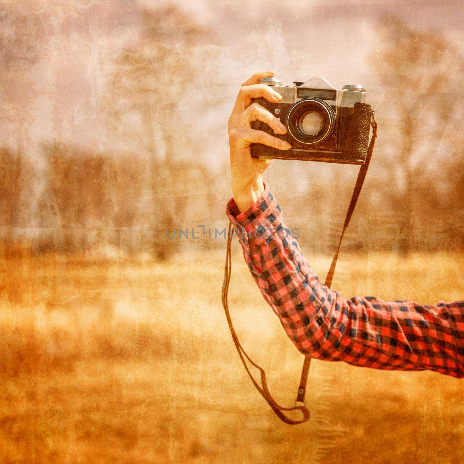 Hand with vintage photo camera by alexAleksei