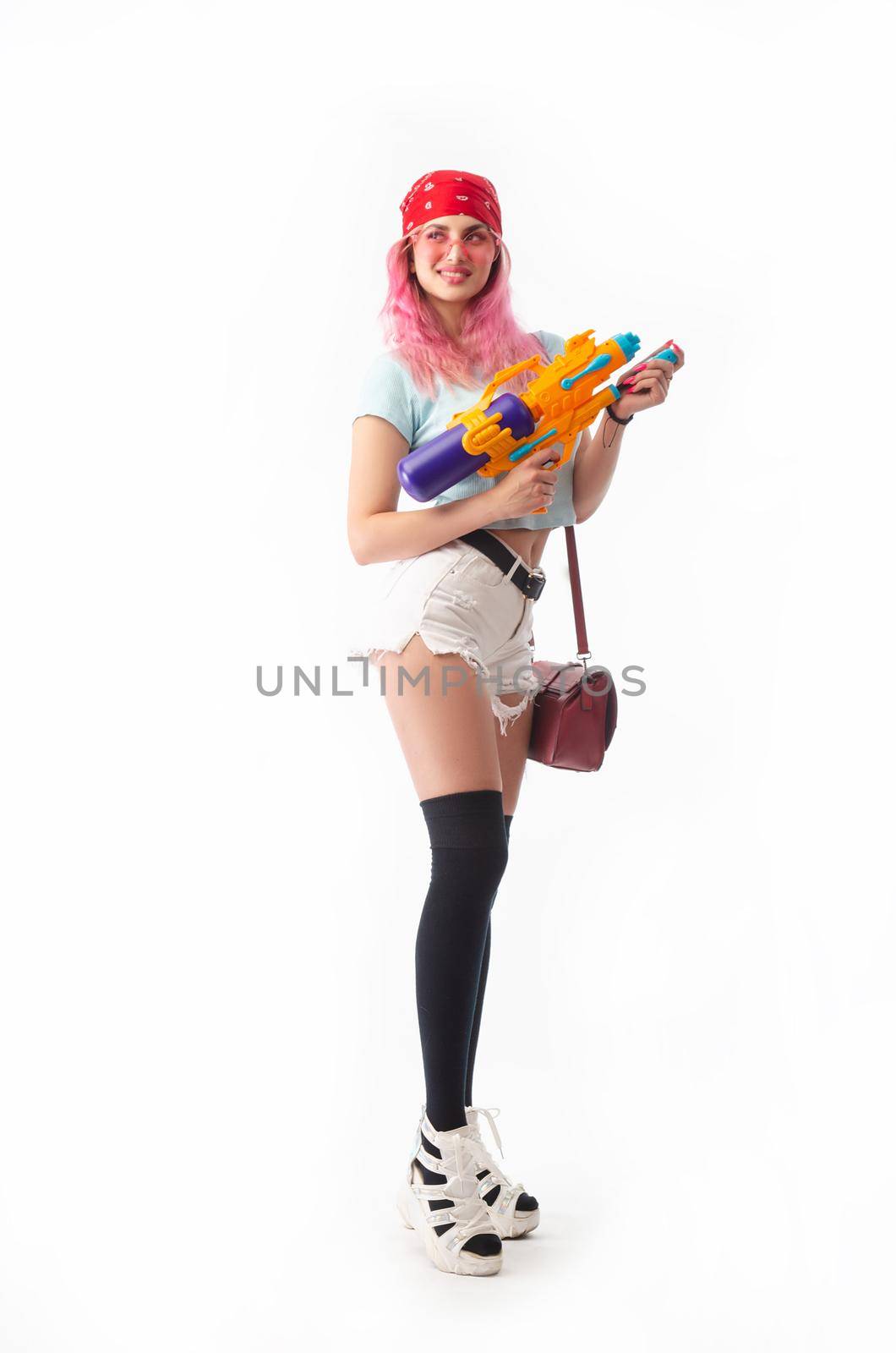 a girl with a water gun in summer clothes, slim and sexy, isolated on a white background drinking coffee