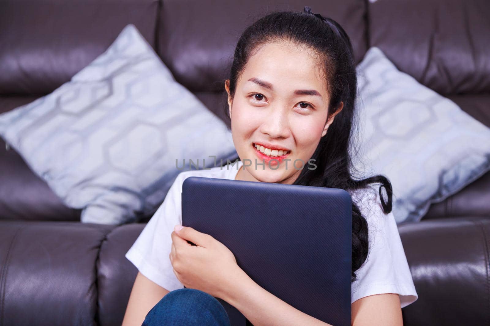 young beautiful woman with laptop computer in living room at home