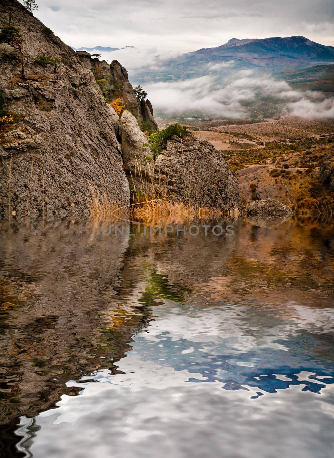 Beautiful view of rocks against the valley with reflection in water