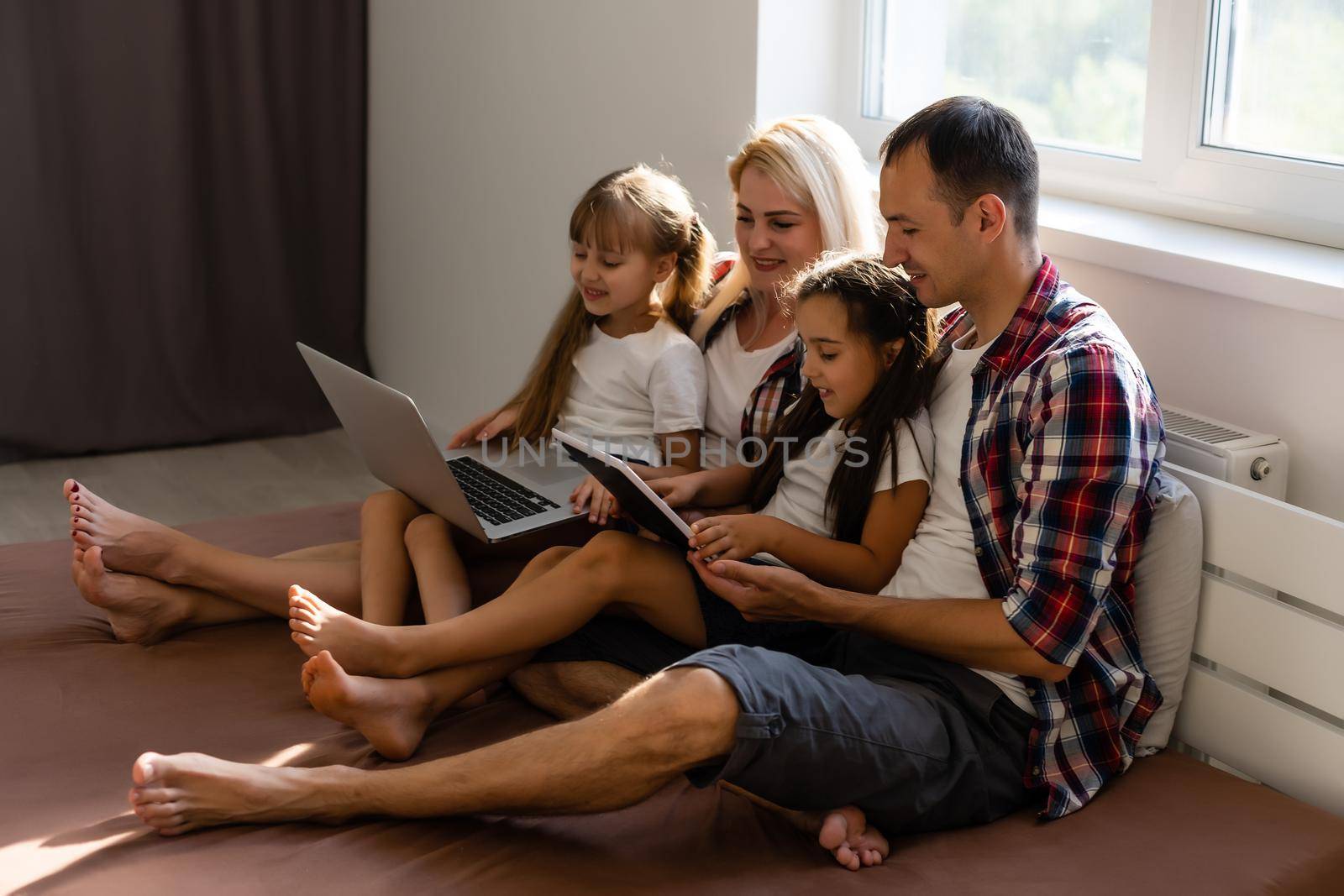 Animated family buying online lying down on bed at home