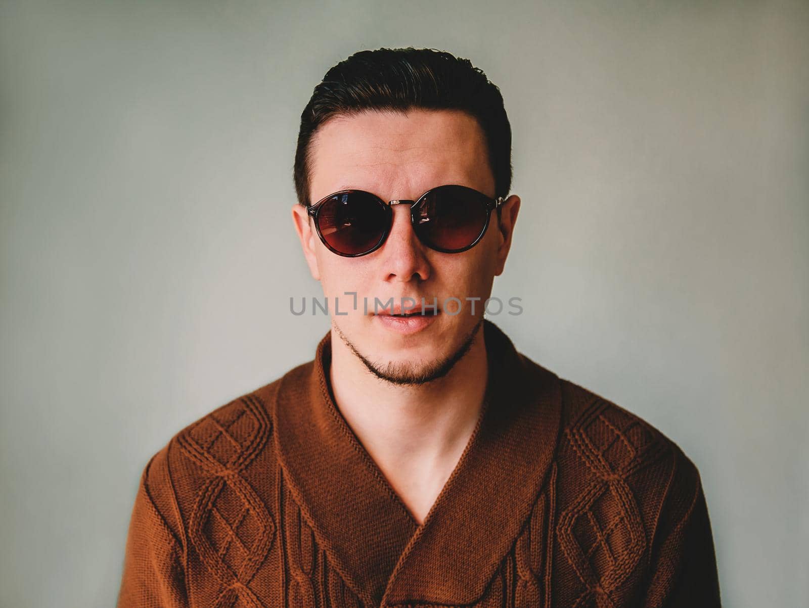 Portrait of handsome young brunet man in sunglasses