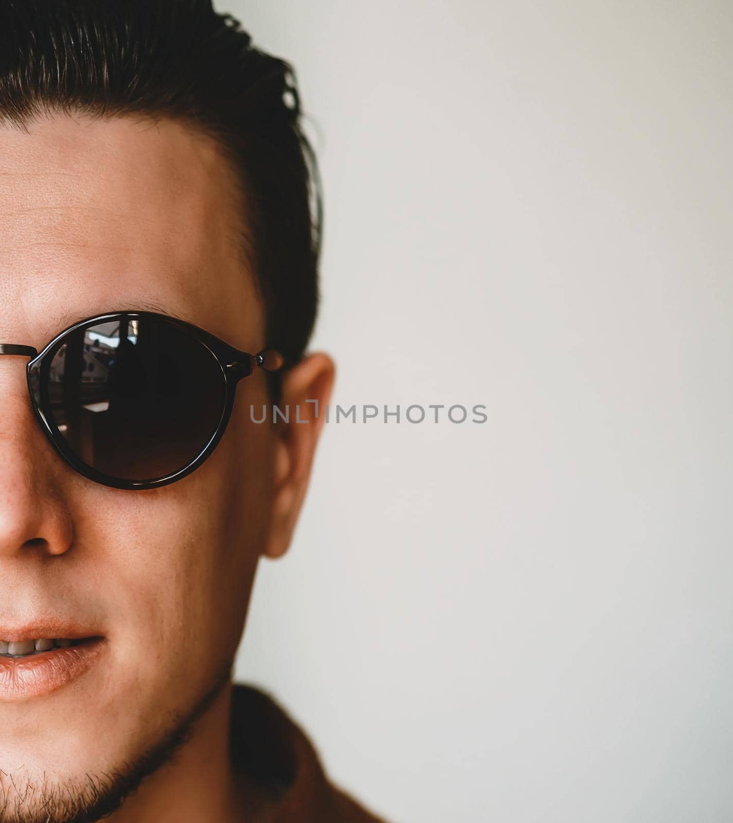 Handsome man in sunglasses. Half face close-up