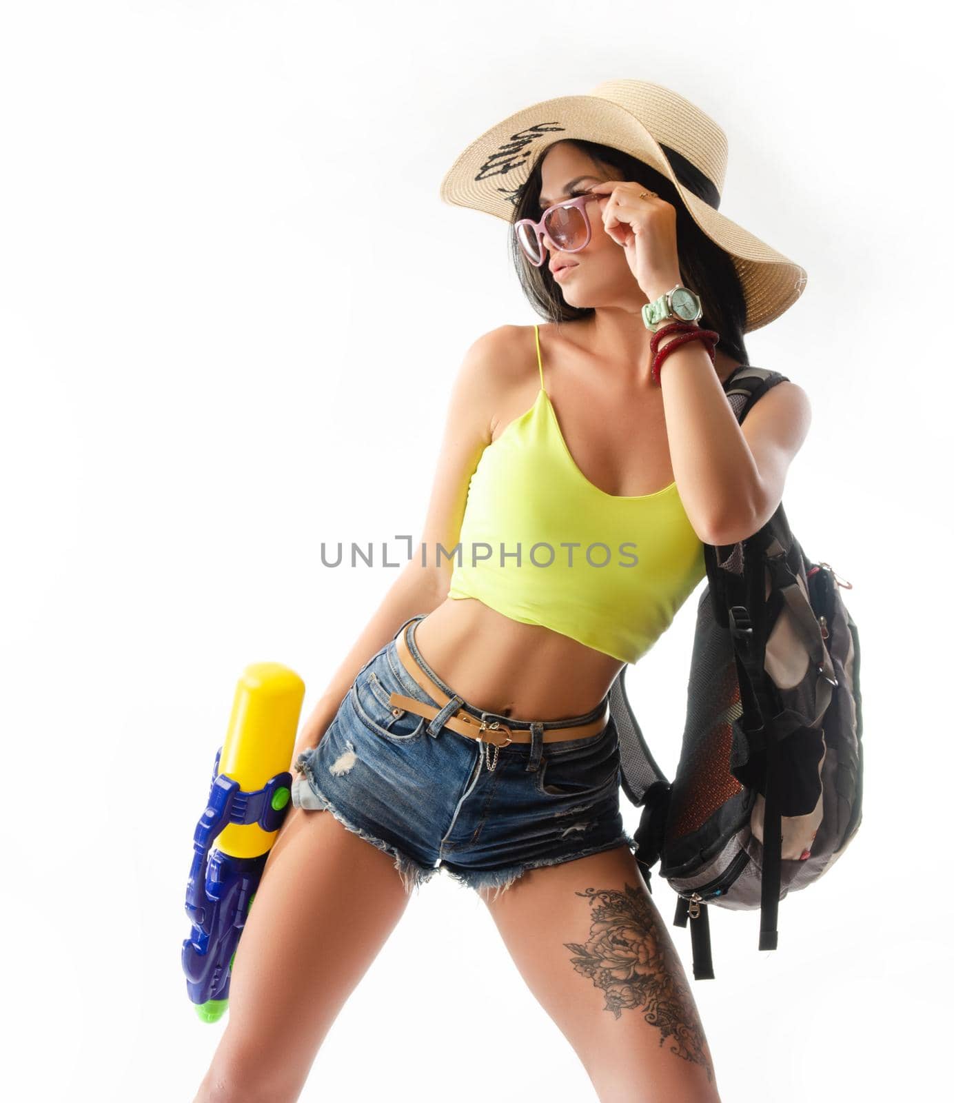 brunette girl with a water gun in summer clothes, slim and sexy by Rotozey