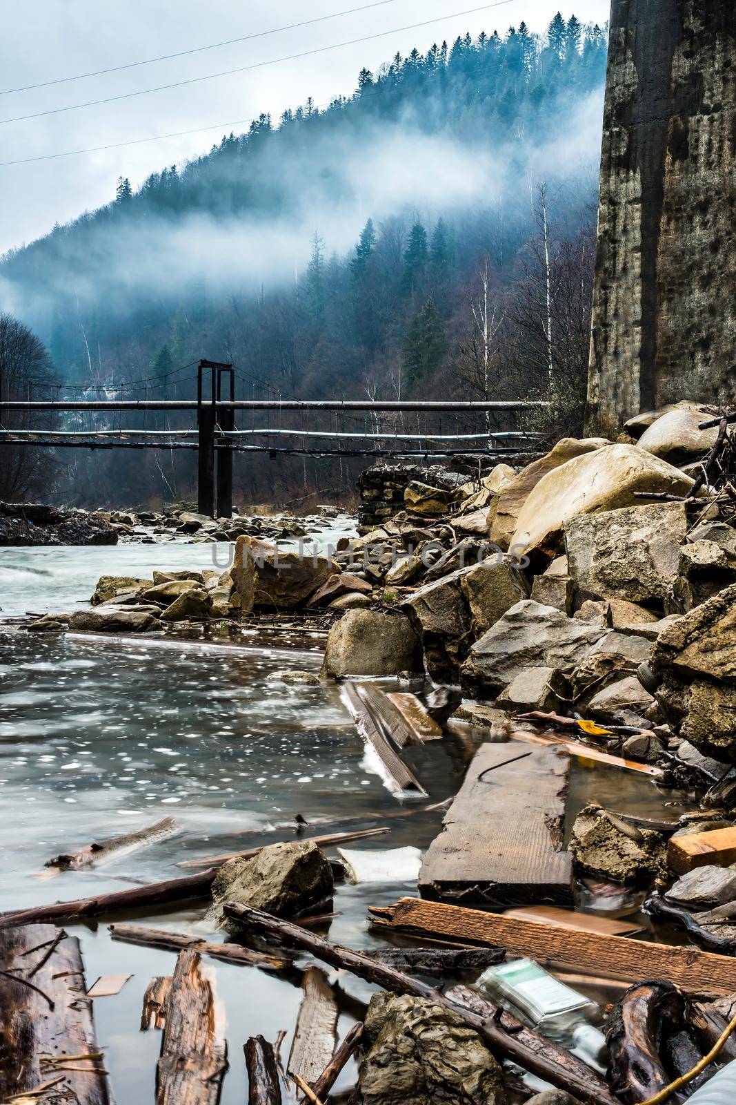 beautiful mountain landscape with lake and bridges in fog in Ukrainian Carpathians