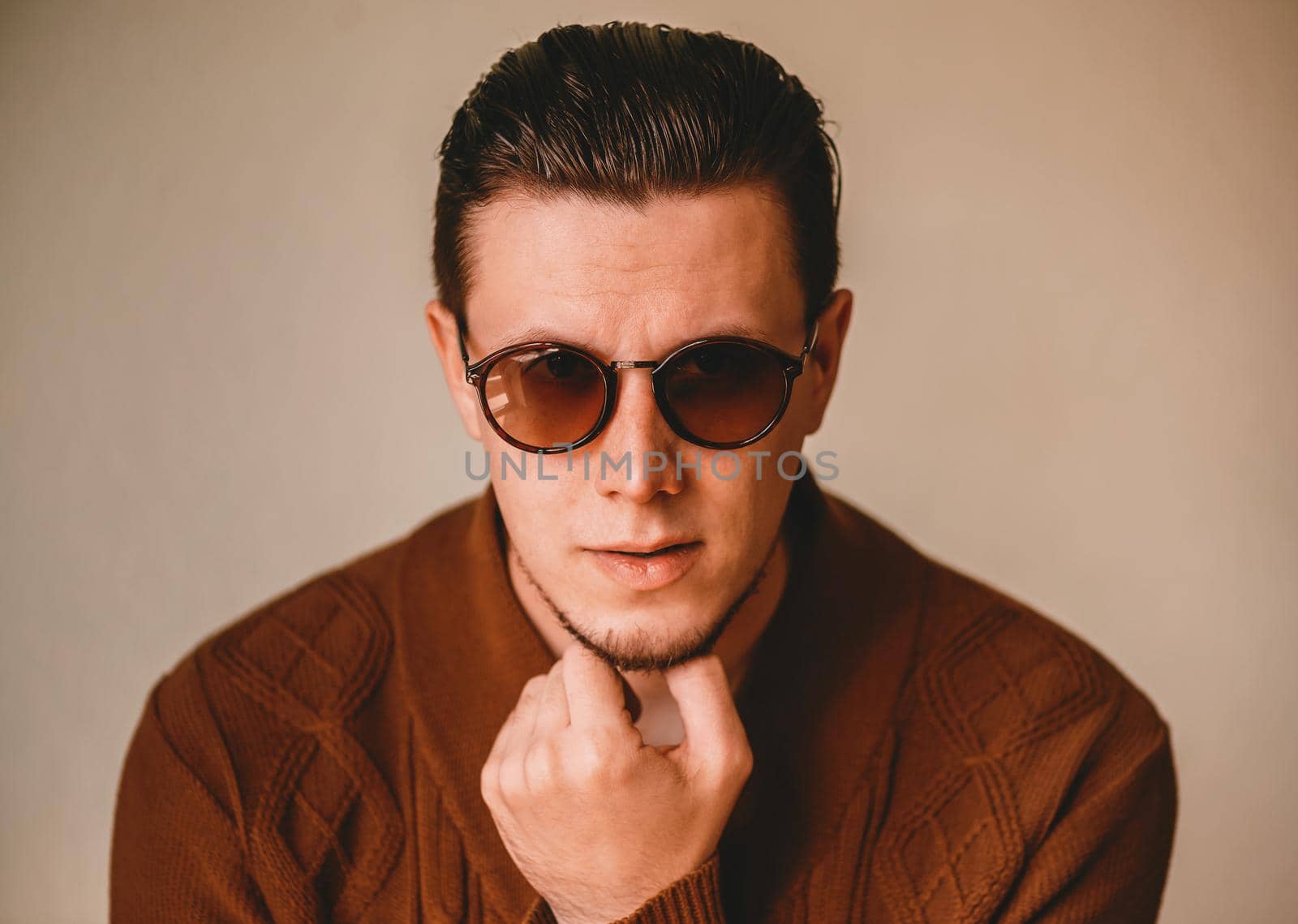 Portrait of handsome brunet man in sunglasses indoor