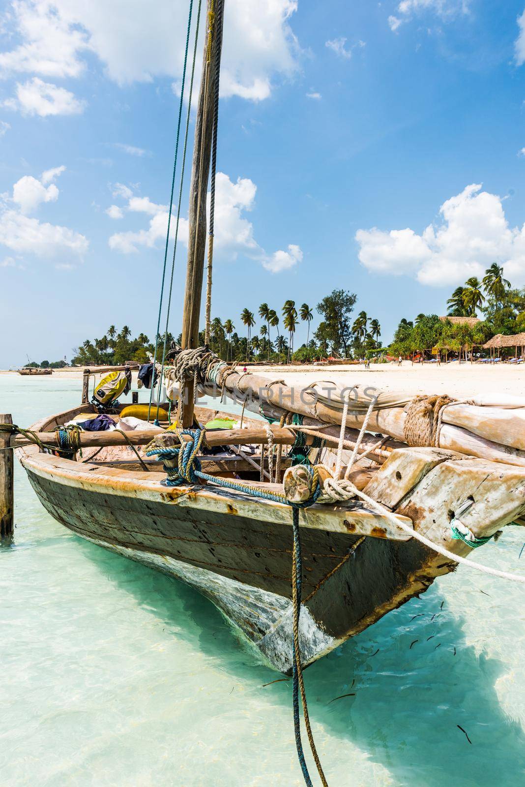 wooden boat on the seashore with beautiful African island and sky on the background