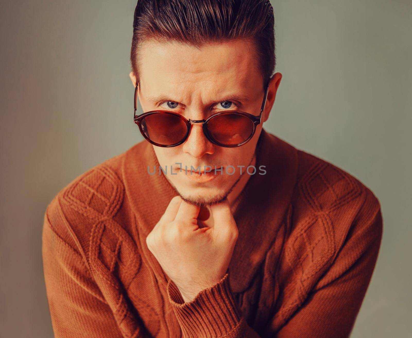 Portrait of handsome fashionable brunet man in sunglasses