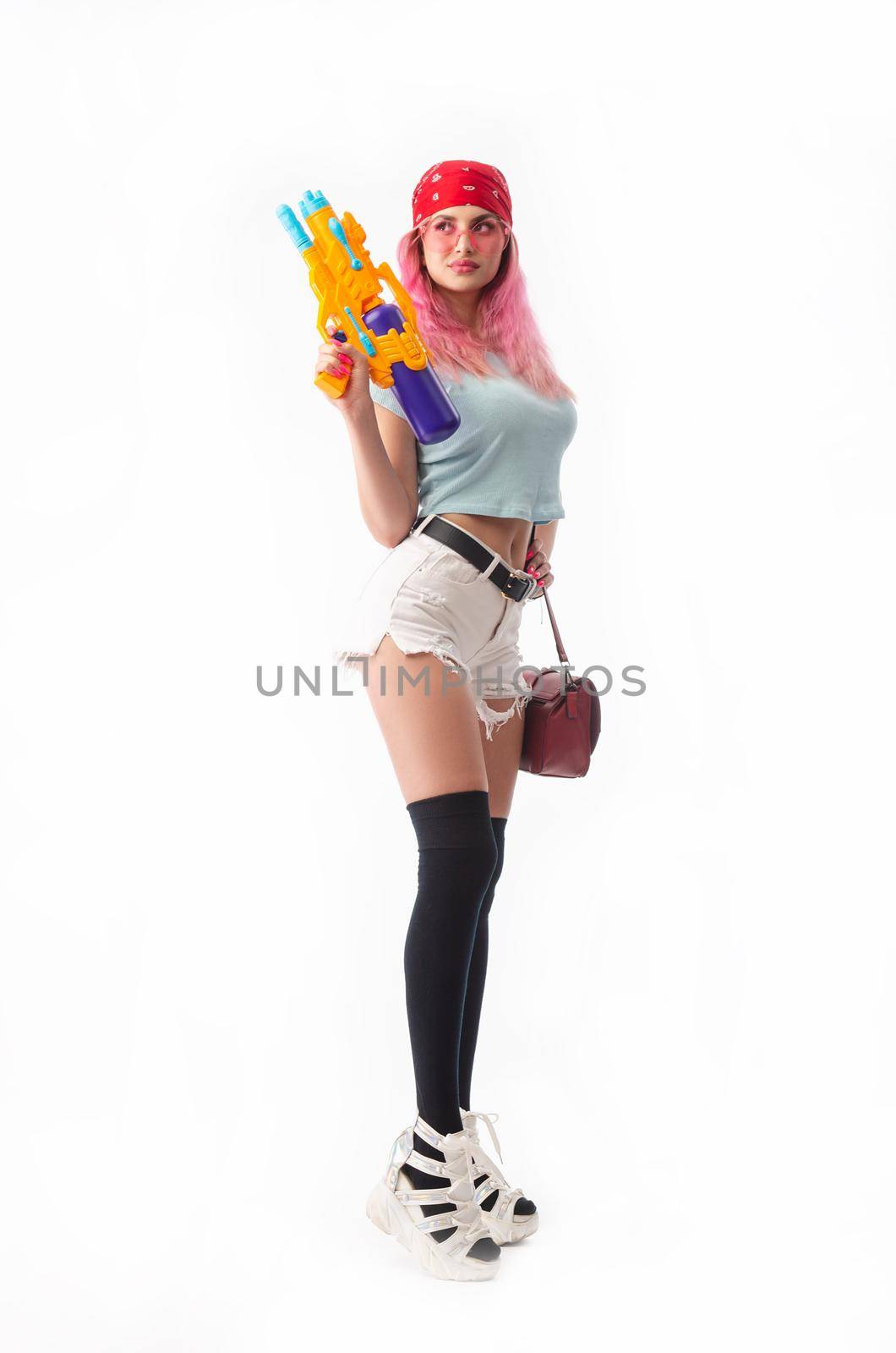 girl with a water gun in summer clothes, slim and sexy isolated on a white background by Rotozey