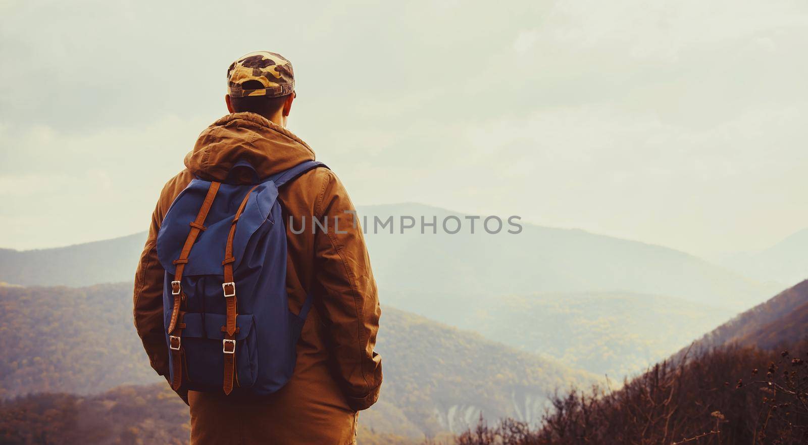 Hiker man enjoying view of mountains by alexAleksei