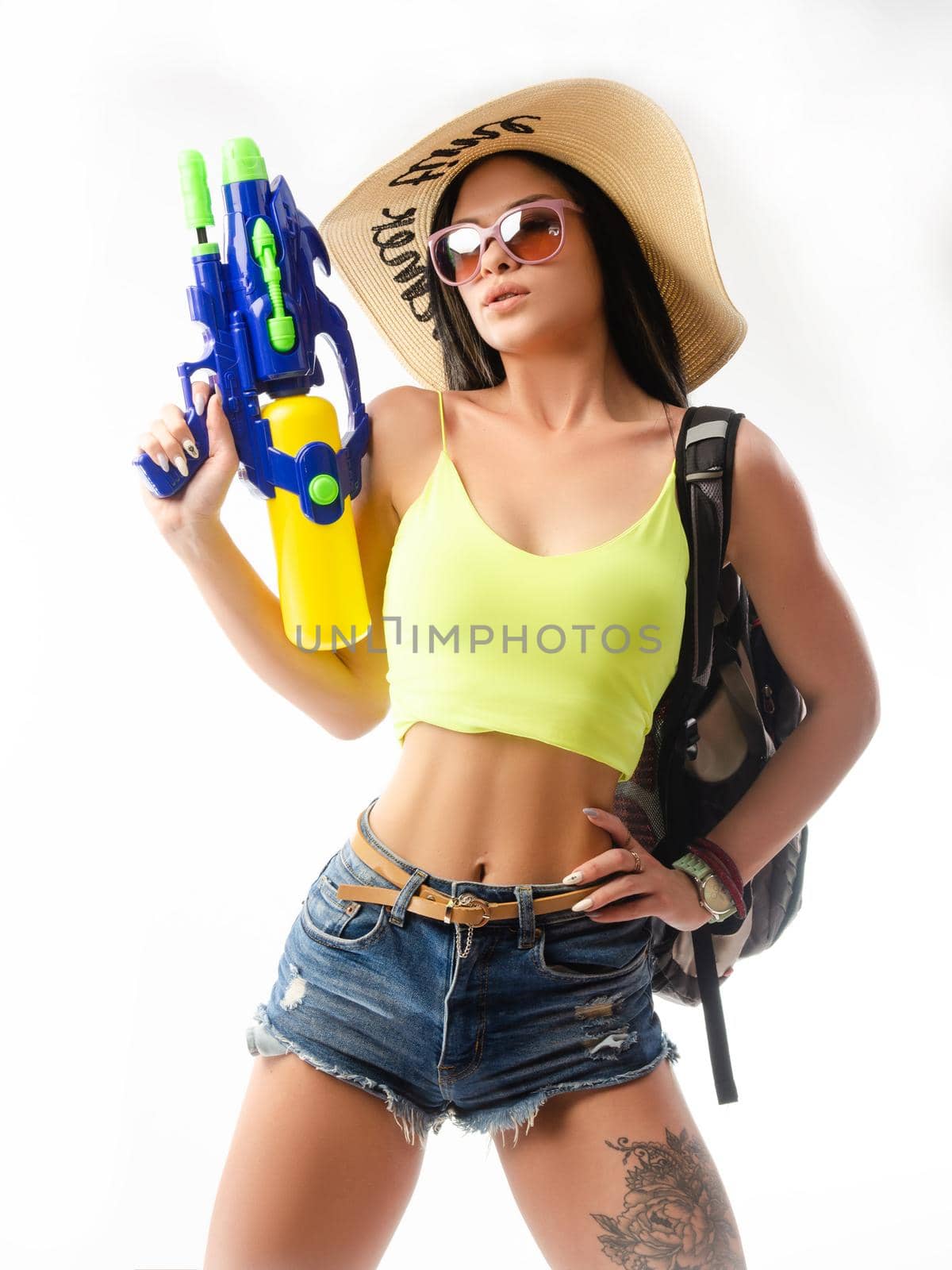 brunette girl with a water gun in summer clothes, slim and sexy by Rotozey