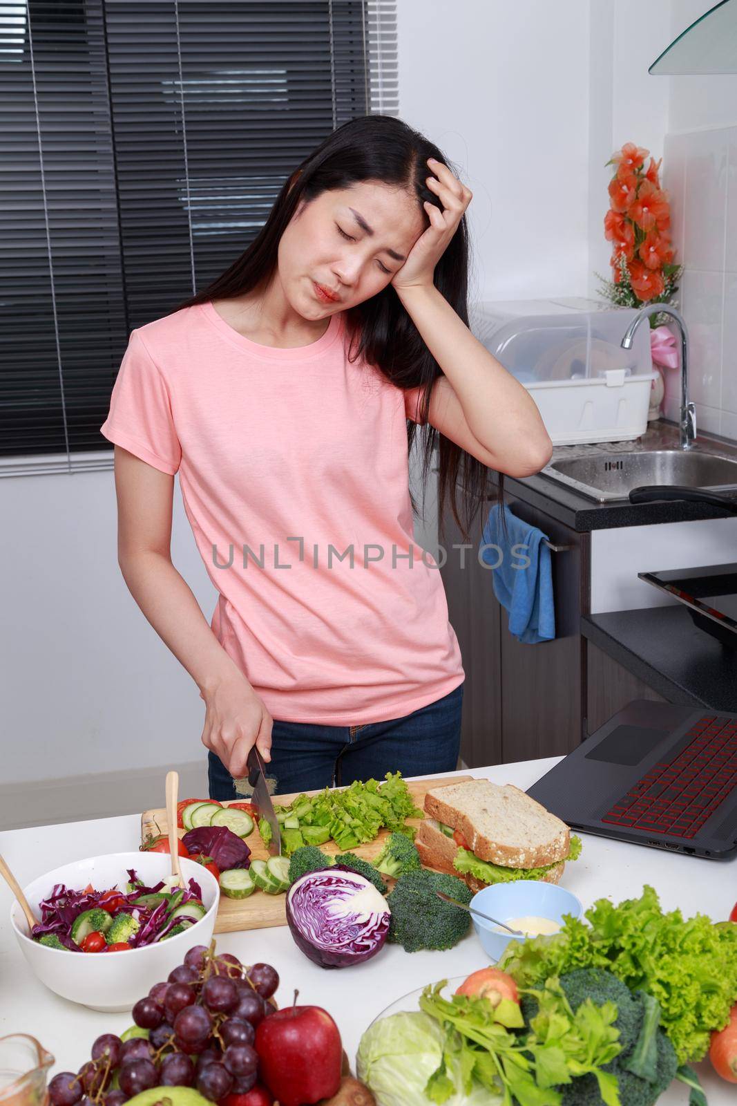 depressed young woman cooking in kitchen room