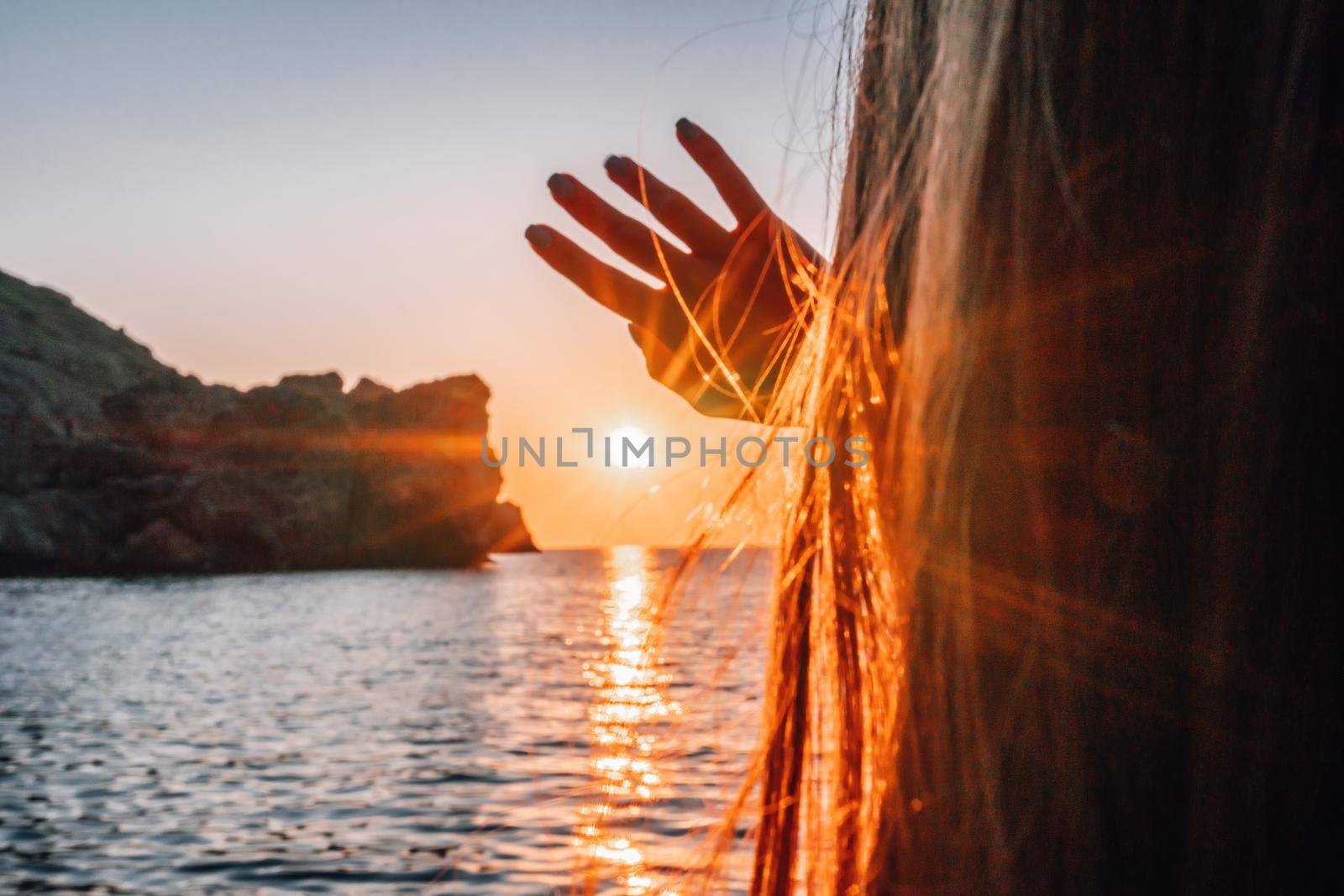 woman traveler drinks coffee with a view of the mountain landscape. A young tourist woman drinks a hot drink from a cup and enjoys the scenery in the mountains. Trekking concept