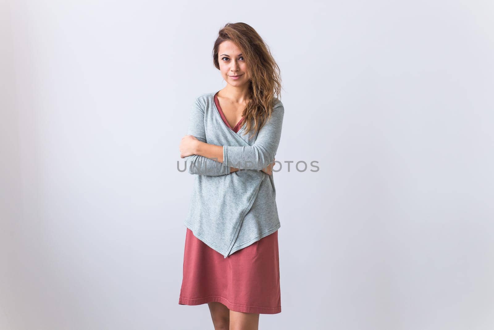 Beautiful young woman smiling against white background. Comfortable homewear, home relaxation and female fashion.