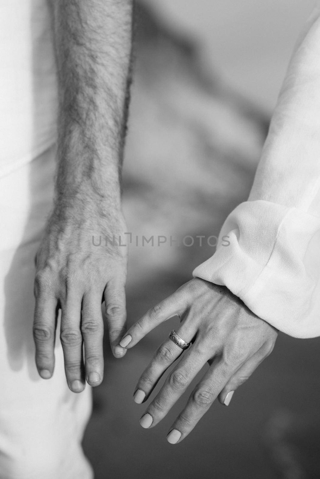 the bride and groom tenderly hold hands between them love and relationships