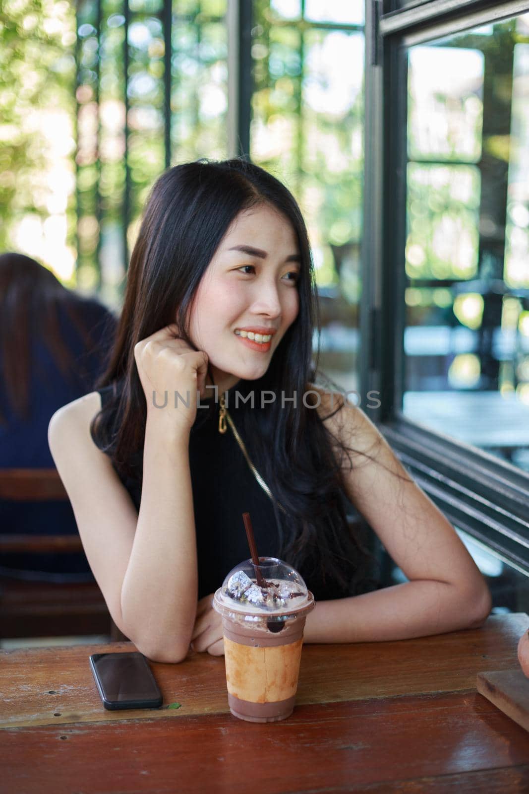 beautiful woman with ice chocolate in the cafe