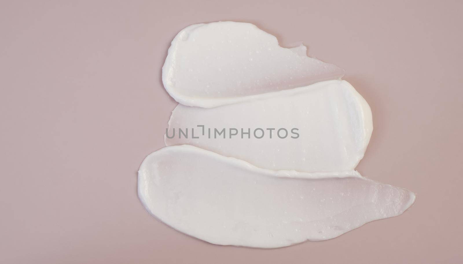 White beauty cream lotion highlighter smear swatch smudge on pink background by Ekaterina34