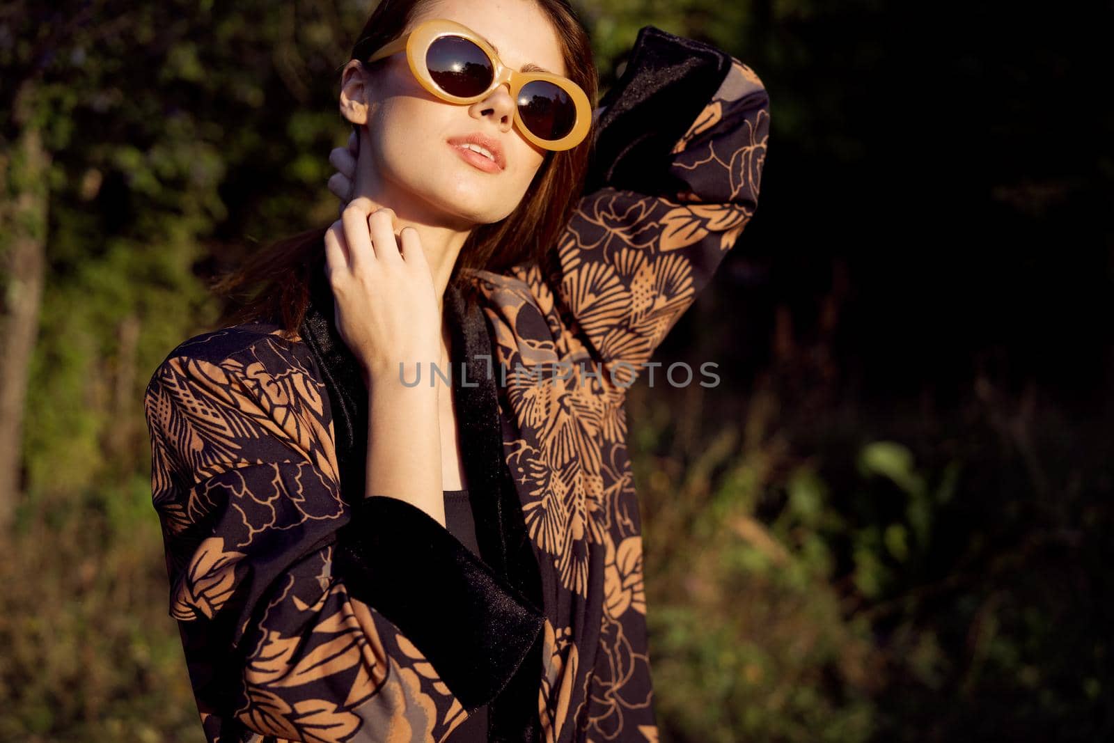 pretty woman wearing sunglasses outdoors fashion nature. High quality photo