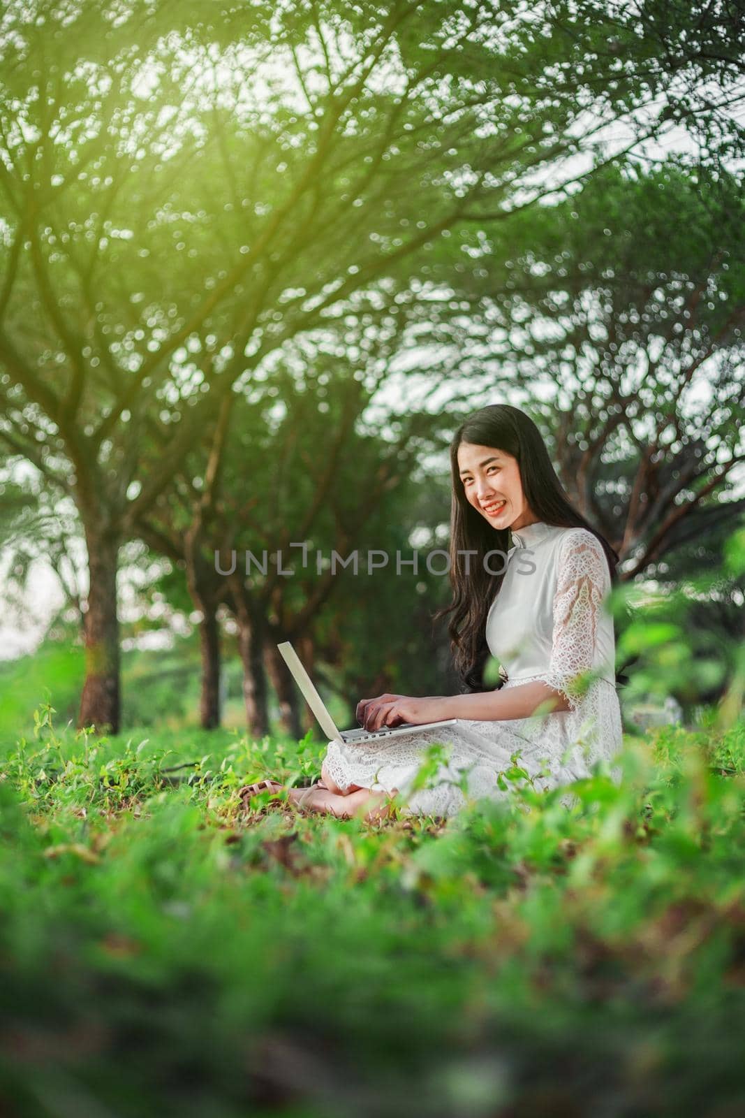 beautiful woman using laptop in the park by geargodz