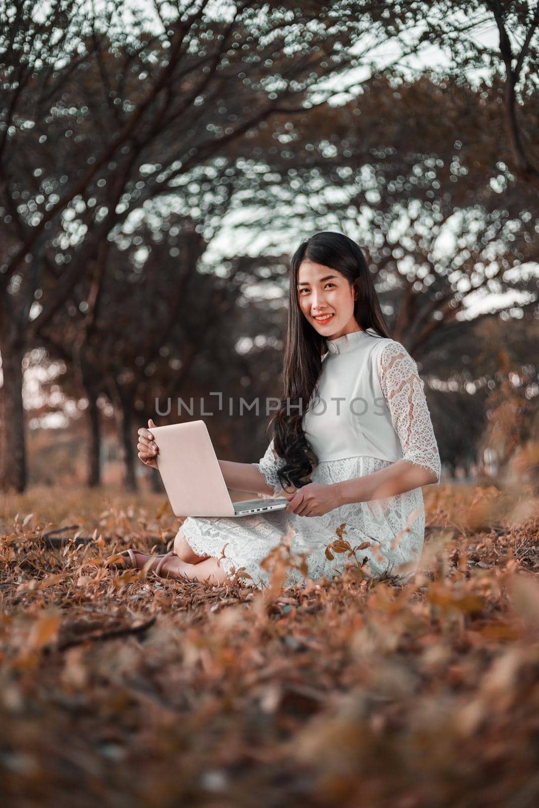 beautiful woman using laptop in the park by geargodz