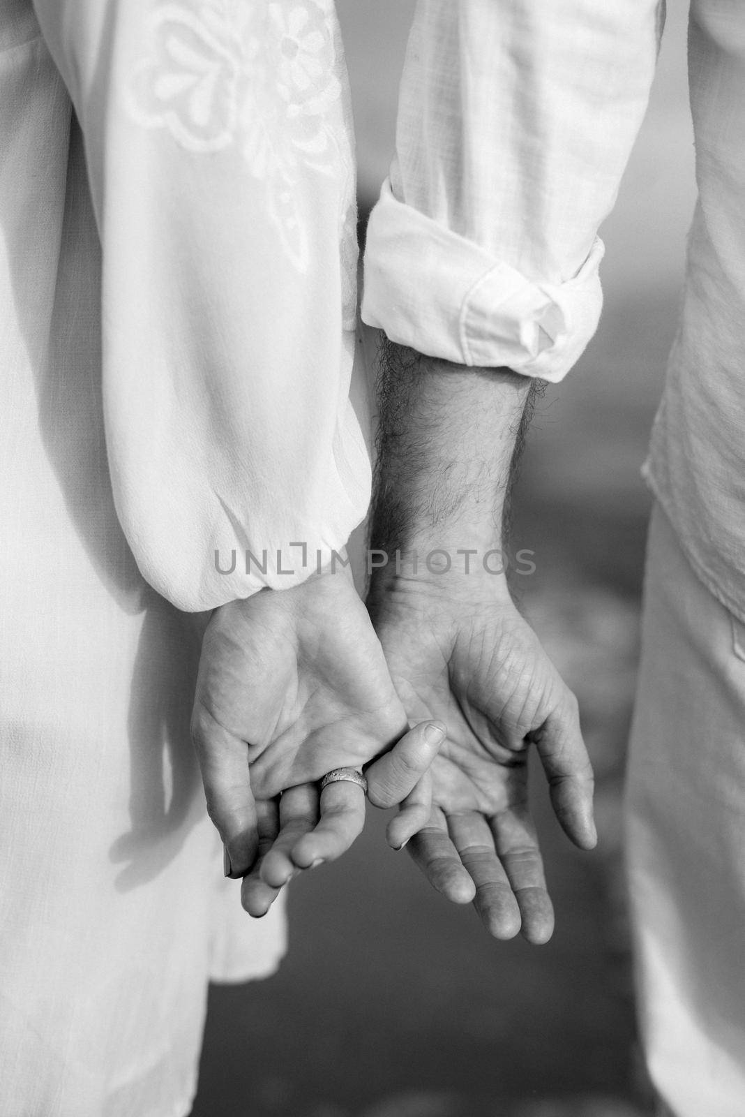 the bride and groom tenderly hold hands between them love and relationships