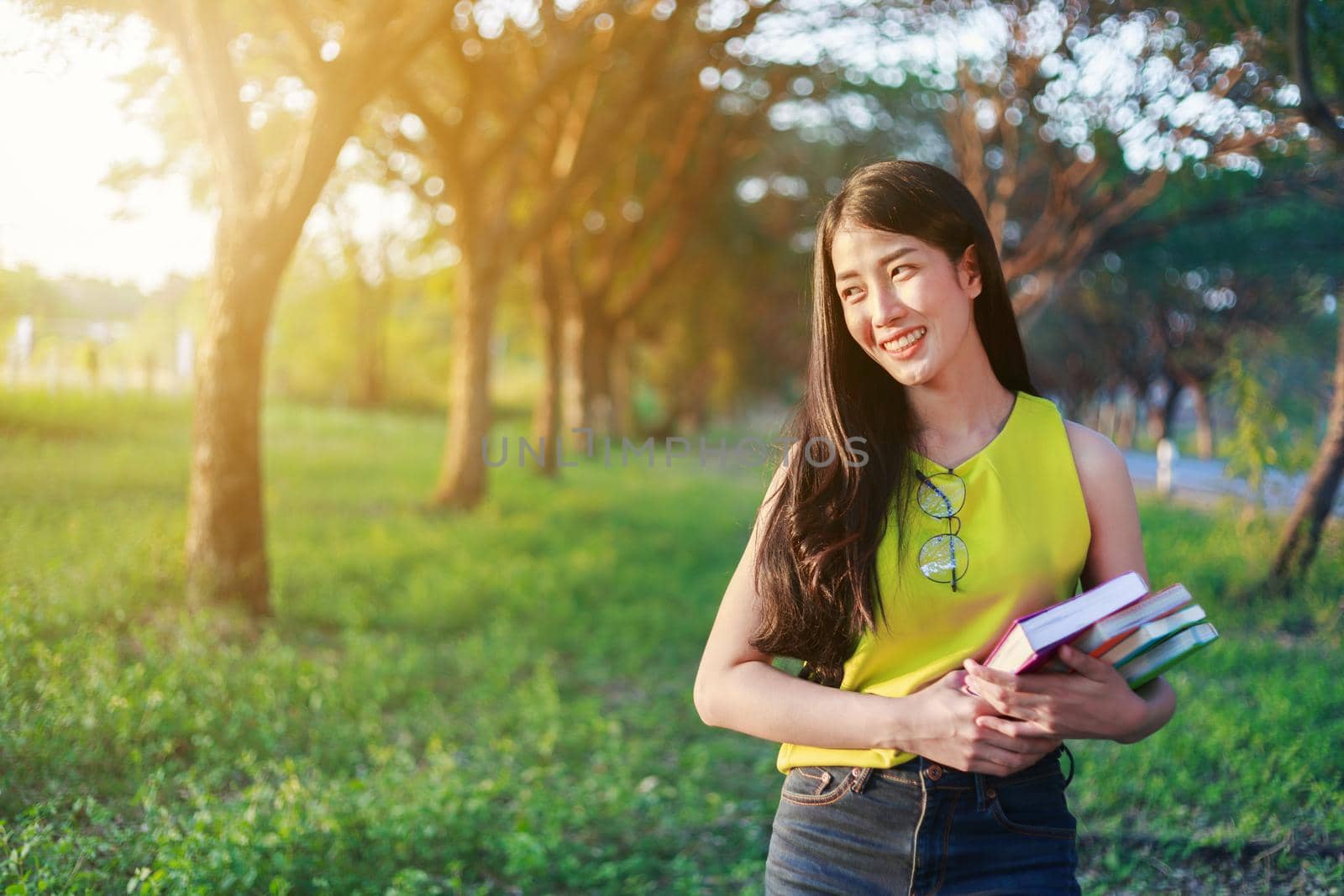 young woman holding with a book in the park