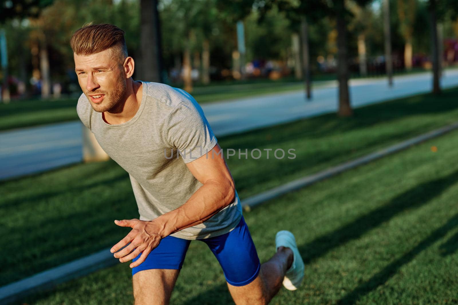 athletic man in the park workout jogging exercise summer. High quality photo