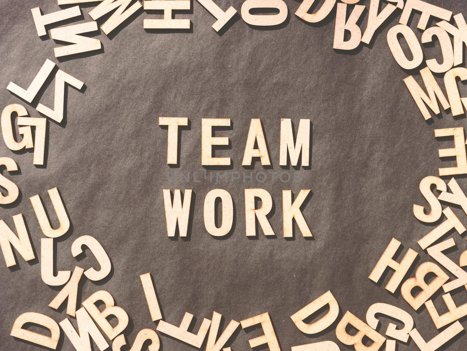 Team Work Word In Wooden Cube Alphabet Letters Top View On A rustic paper Background. by sudiptabhowmick