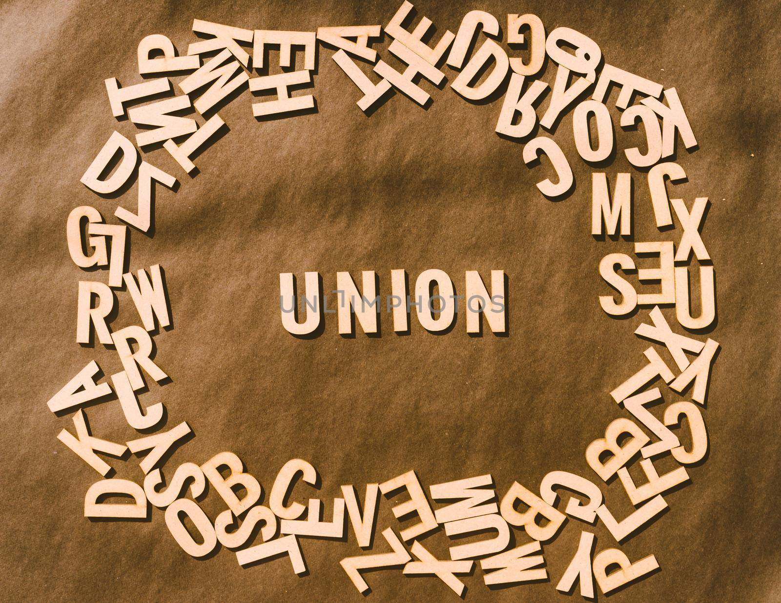 Union Word In Wooden Cube Alphabet Letters Top View On A rustic paper Background.