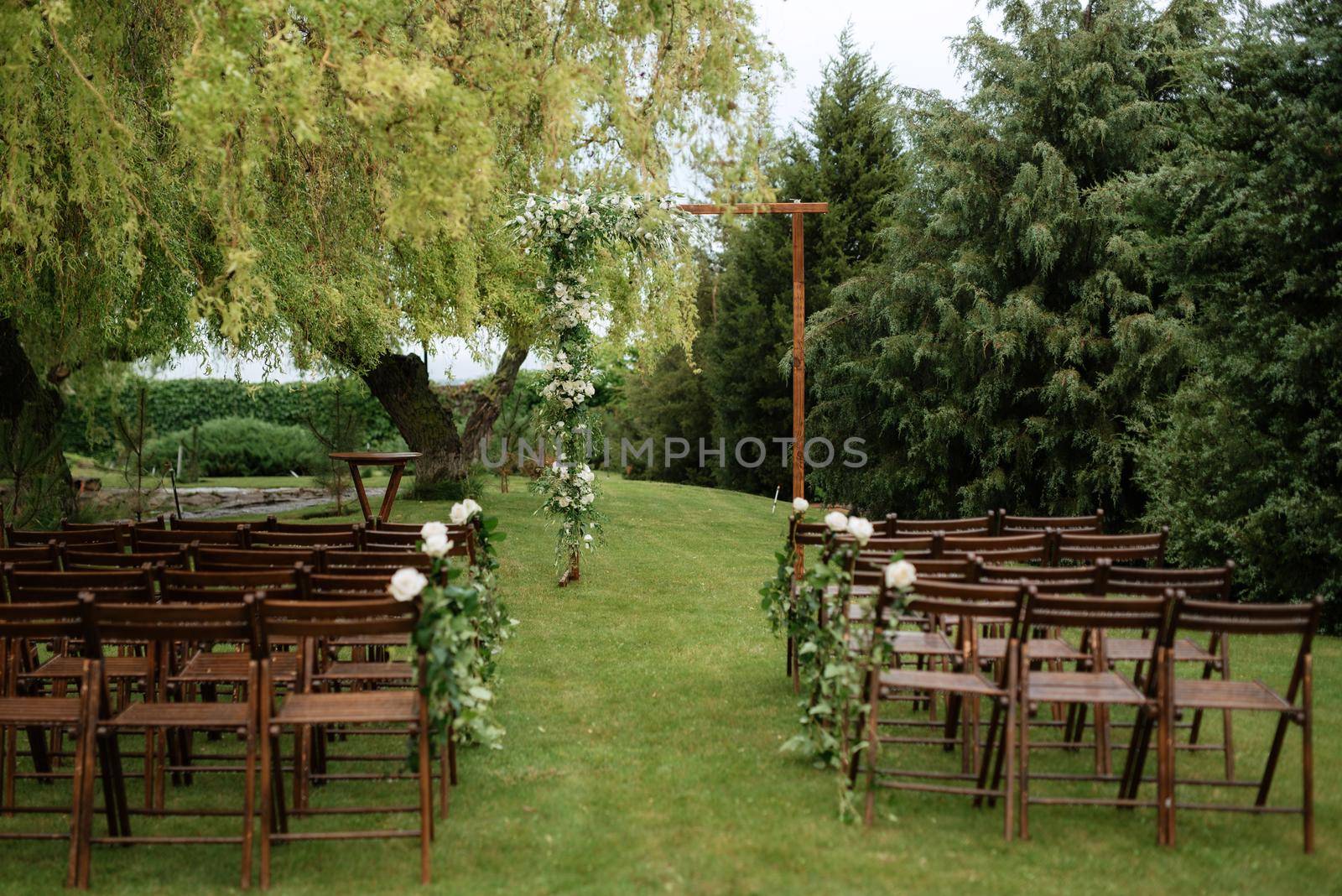 wedding ceremony area with dried flowers in a meadow in a forest by Andreua
