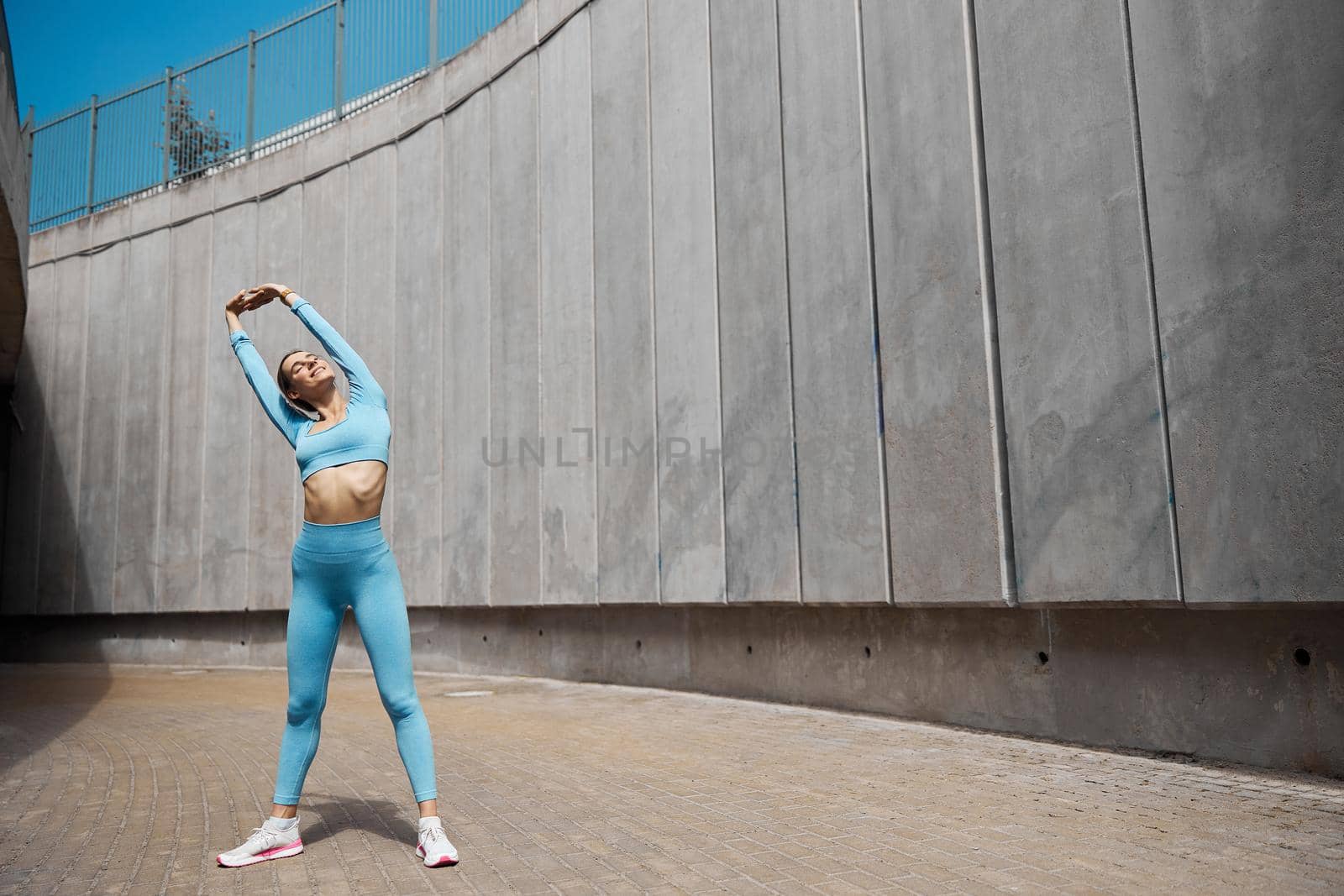 Beautiful fit young woman jogger is running outdoors by Yaroslav_astakhov