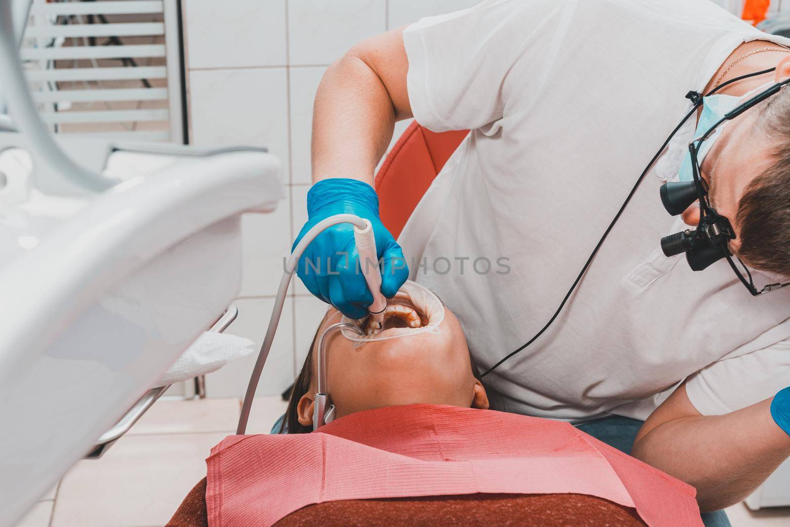 The dentist uses a scaler to remove tartar, oral hygiene.2020