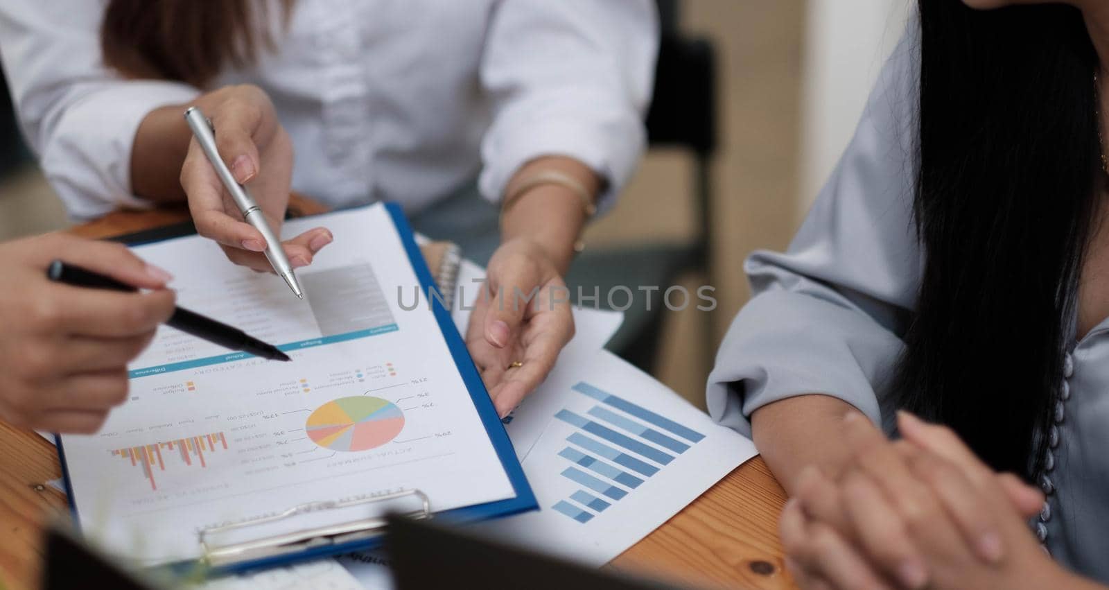 Close up Business people meeting to discuss the situation on the market. Business Financial Concept by wichayada