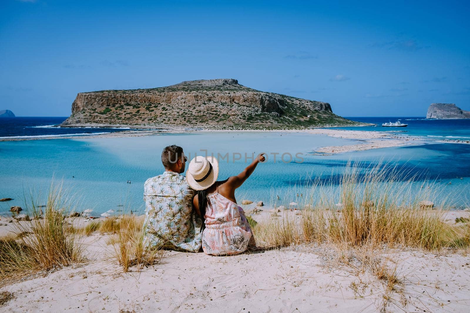 Crete Greece, Balos lagoon on Crete island, Greece. Tourists relax and bath in crystal clear water of Balos beach. Greece, couple men and woman visiting the beach