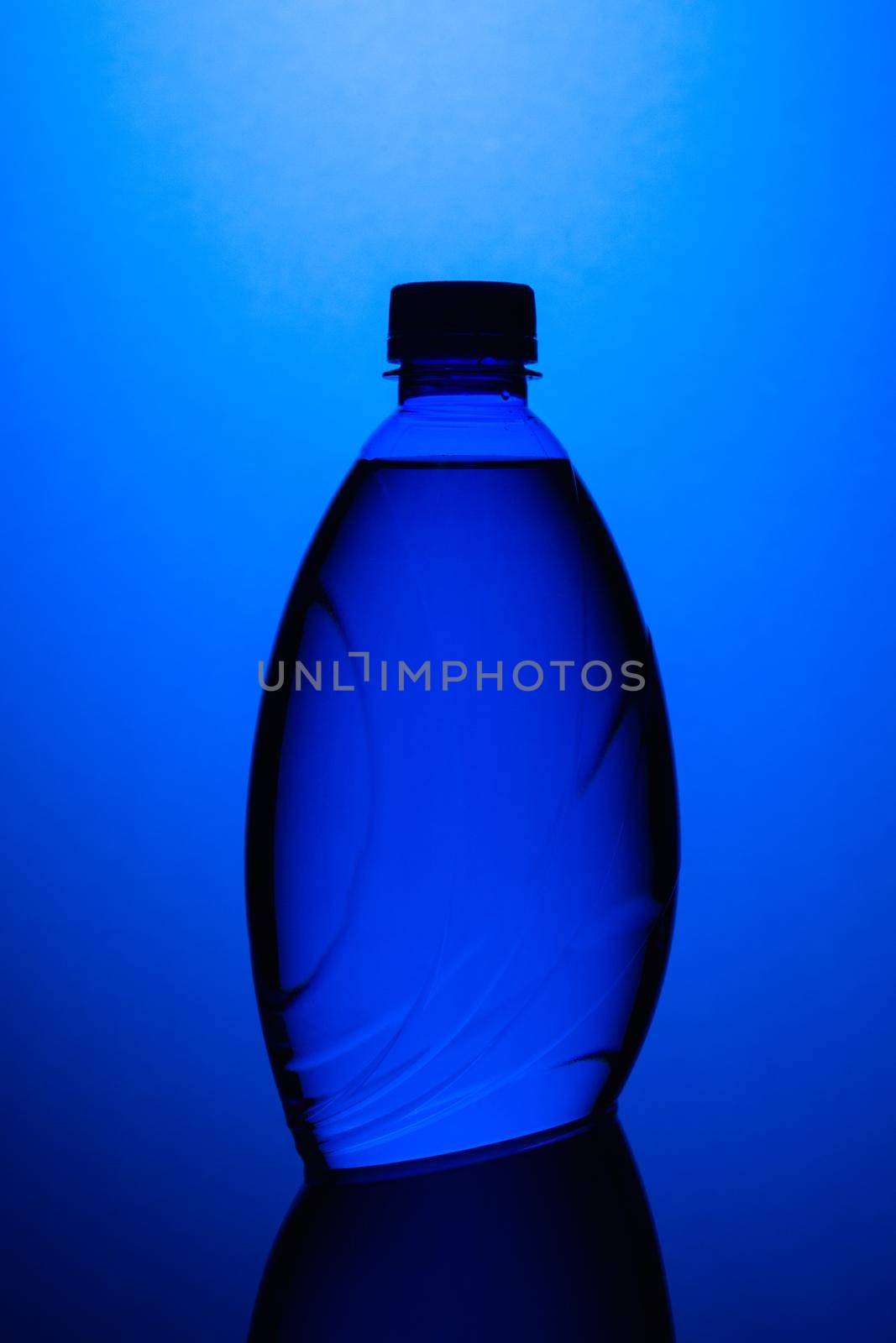 Blue plastic bottle on the blue background.  by CaptureLight