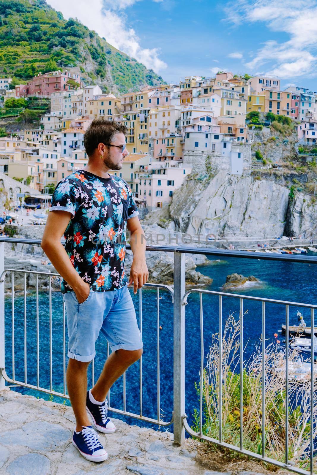 Manarola village, Cinque Terre park Italy during a summer day, vacation Italy colorful coast Manarola Cinque Terre Italy. Man watching the sunset