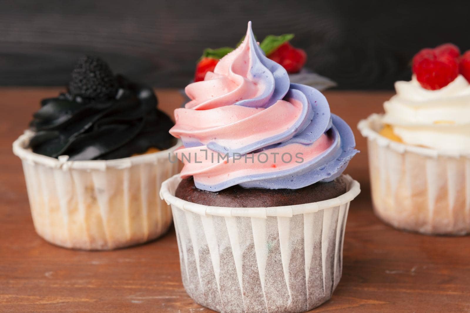 Delicious raspberry cupcakes on dark background - Handmade Sweet dessert