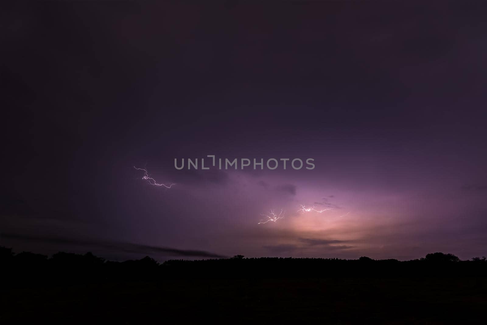 Sky background and lightning bolt at night by yayimage