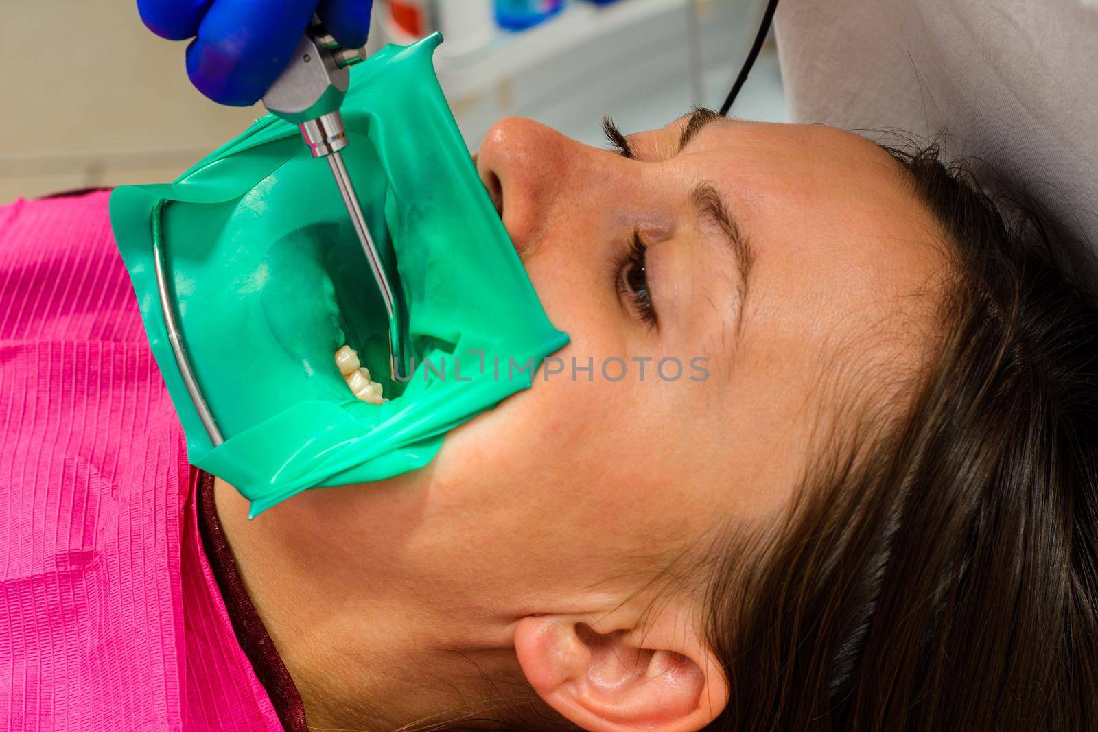 The dentist installs a rubber dam, sterile dental treatment, modern equipment in dentistry.2020