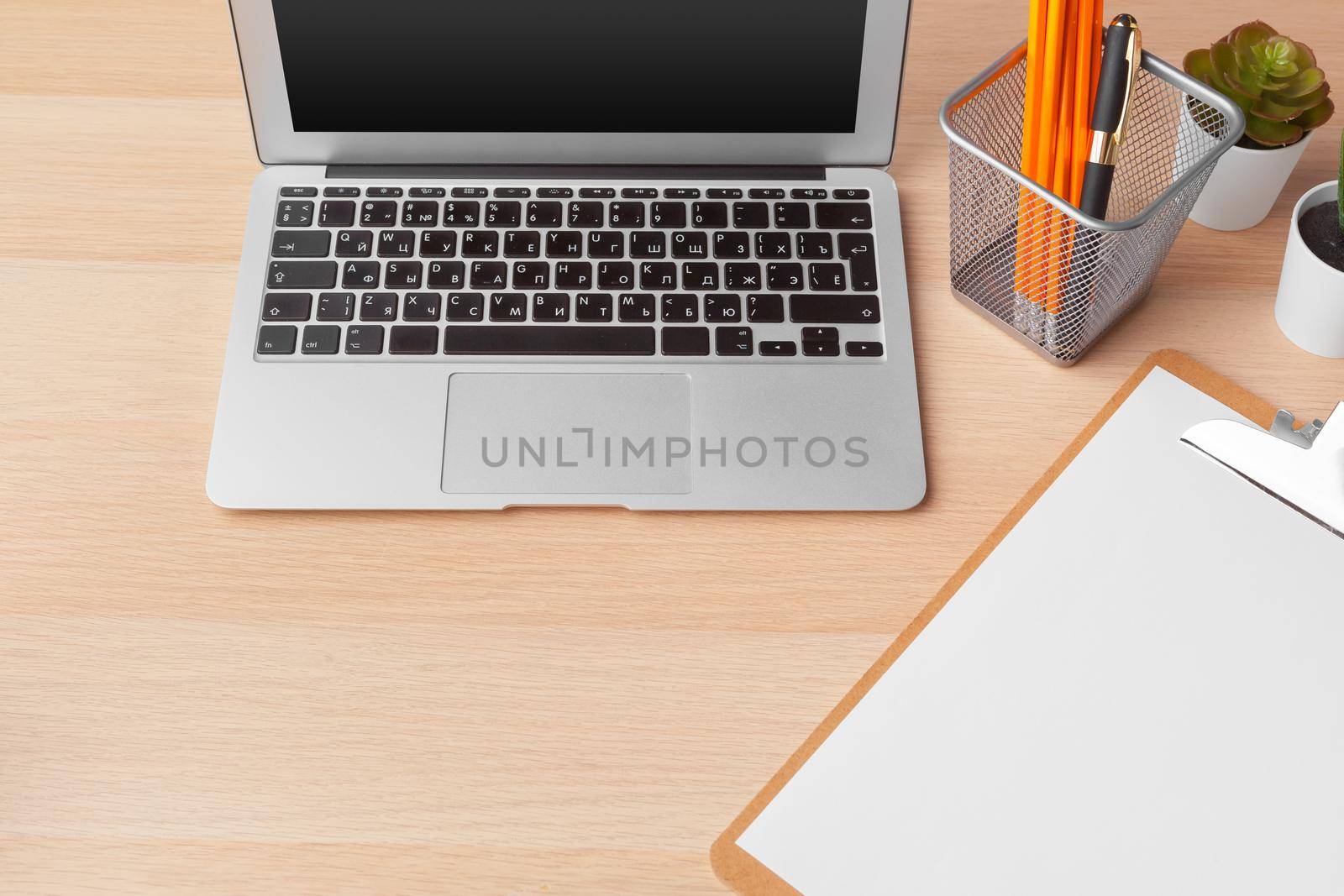 paperwork in the office and laptop on the desktop