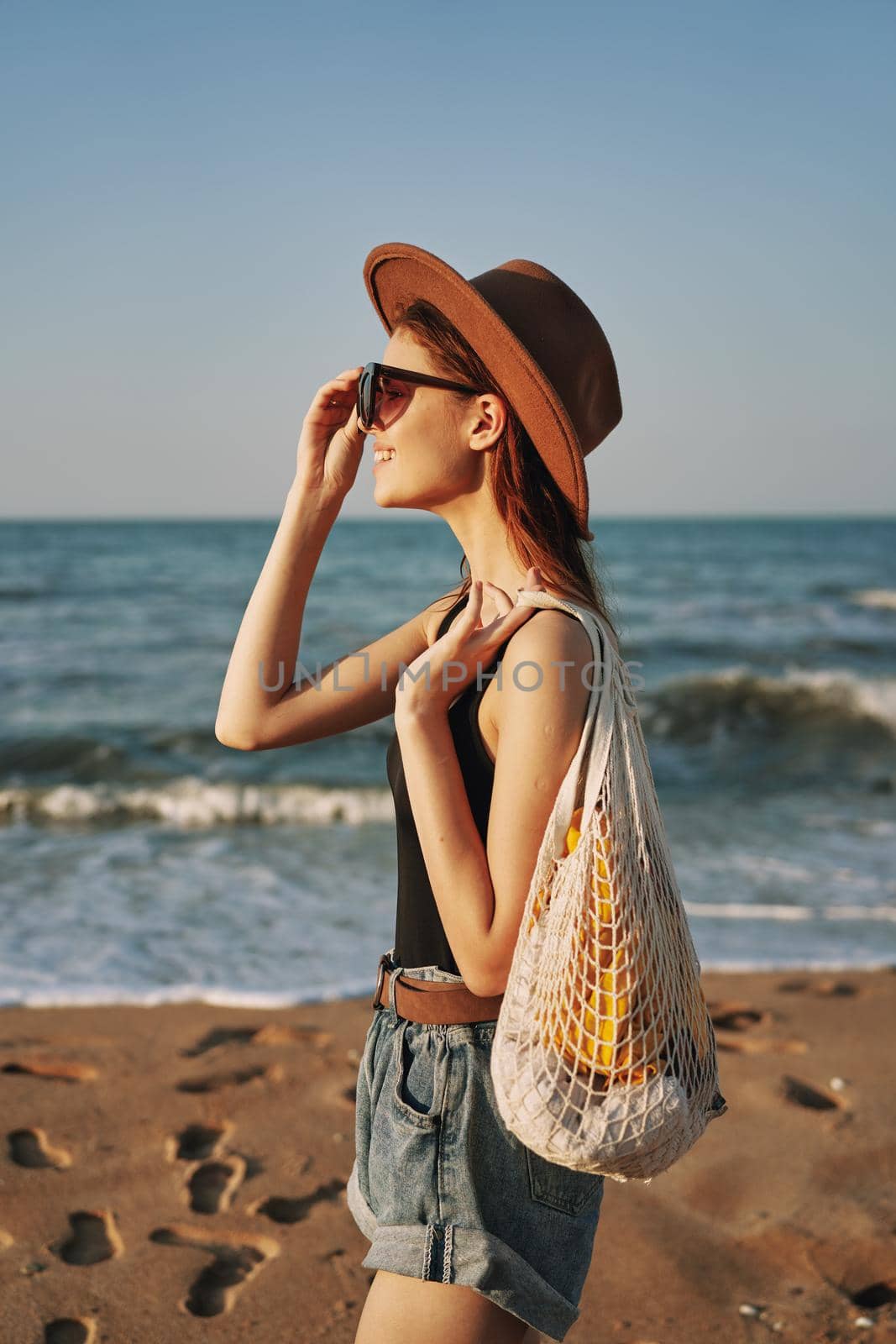 woman walking on the beach landscape sun fun lifestyle. High quality photo