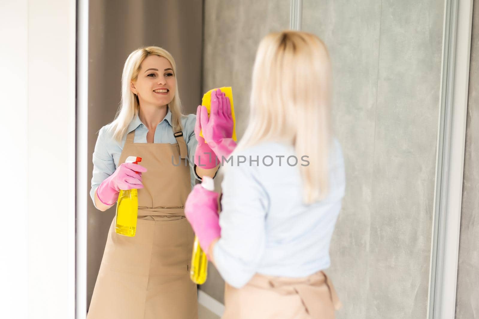 Adult woman is cleaning the apartment